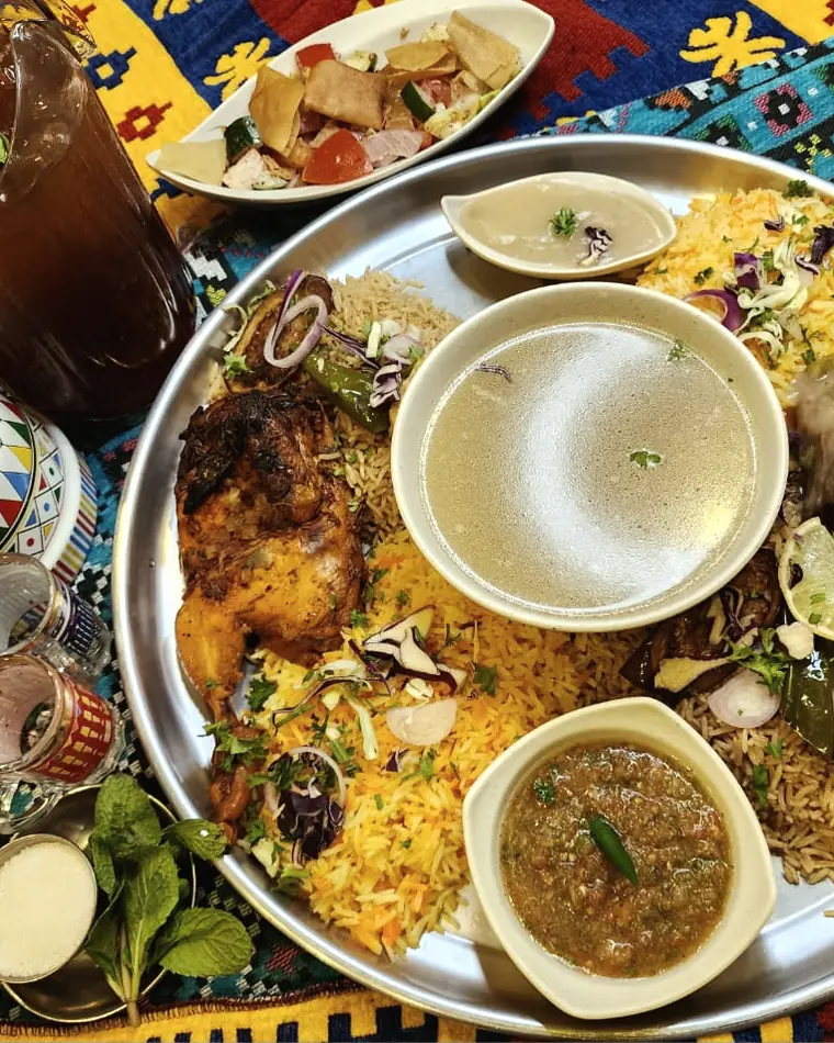 A family dulang set with Mandy and Makloba rice, lamb and chicken at Wadi Hana Elarabi Johor Bahru